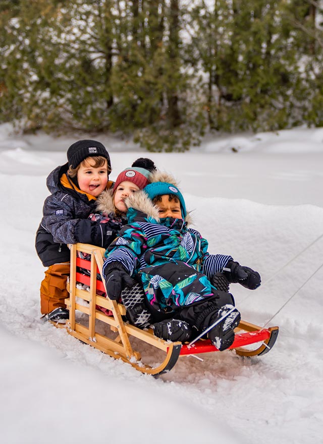 Enfants qui font du traîneau sur la neige